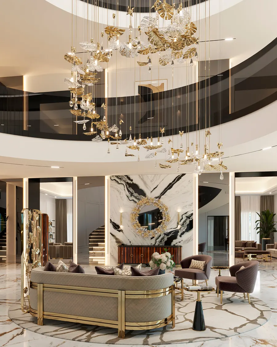 Round hotel lobby with a sculptural brass chandelier, marble feature wall and lounge seating