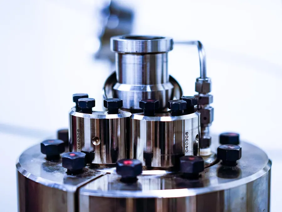 Close-up of a precision stainless steel assembly with bolted flanges