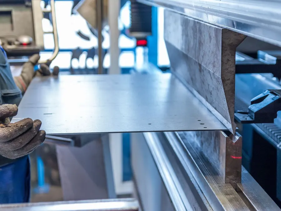 Sheet held against the back gauge of a press brake during bending