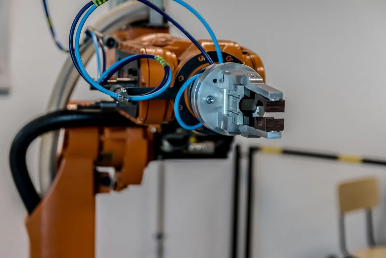 Orange industrial robot arm with a vacuum gripper