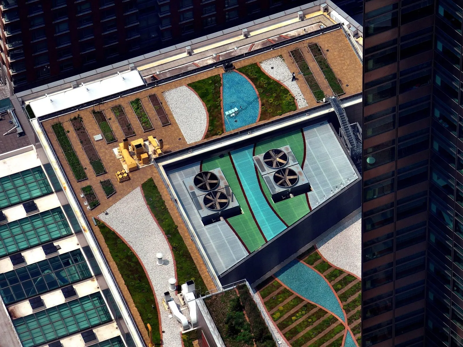 Aerial view of an office roof with heat-pump fans and a green roof