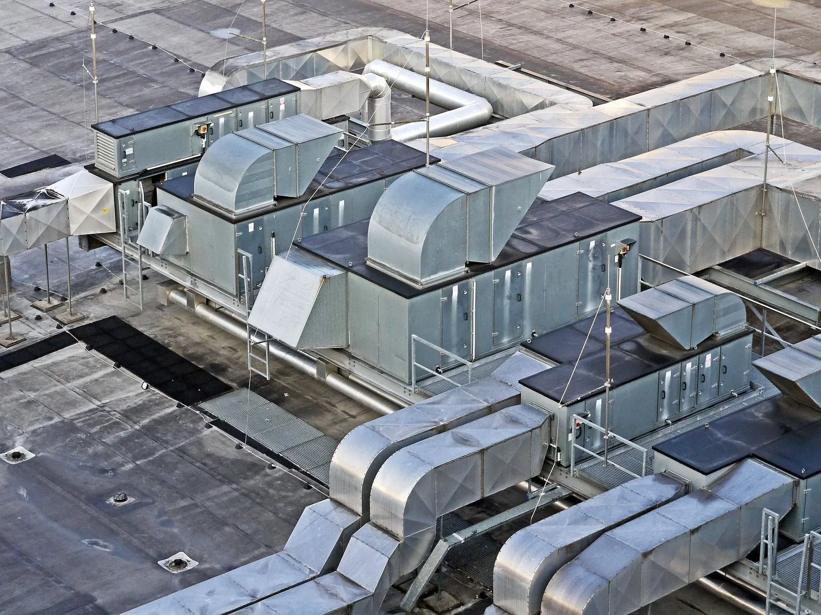 Air handling units and insulated ductwork on the flat roof of an office building