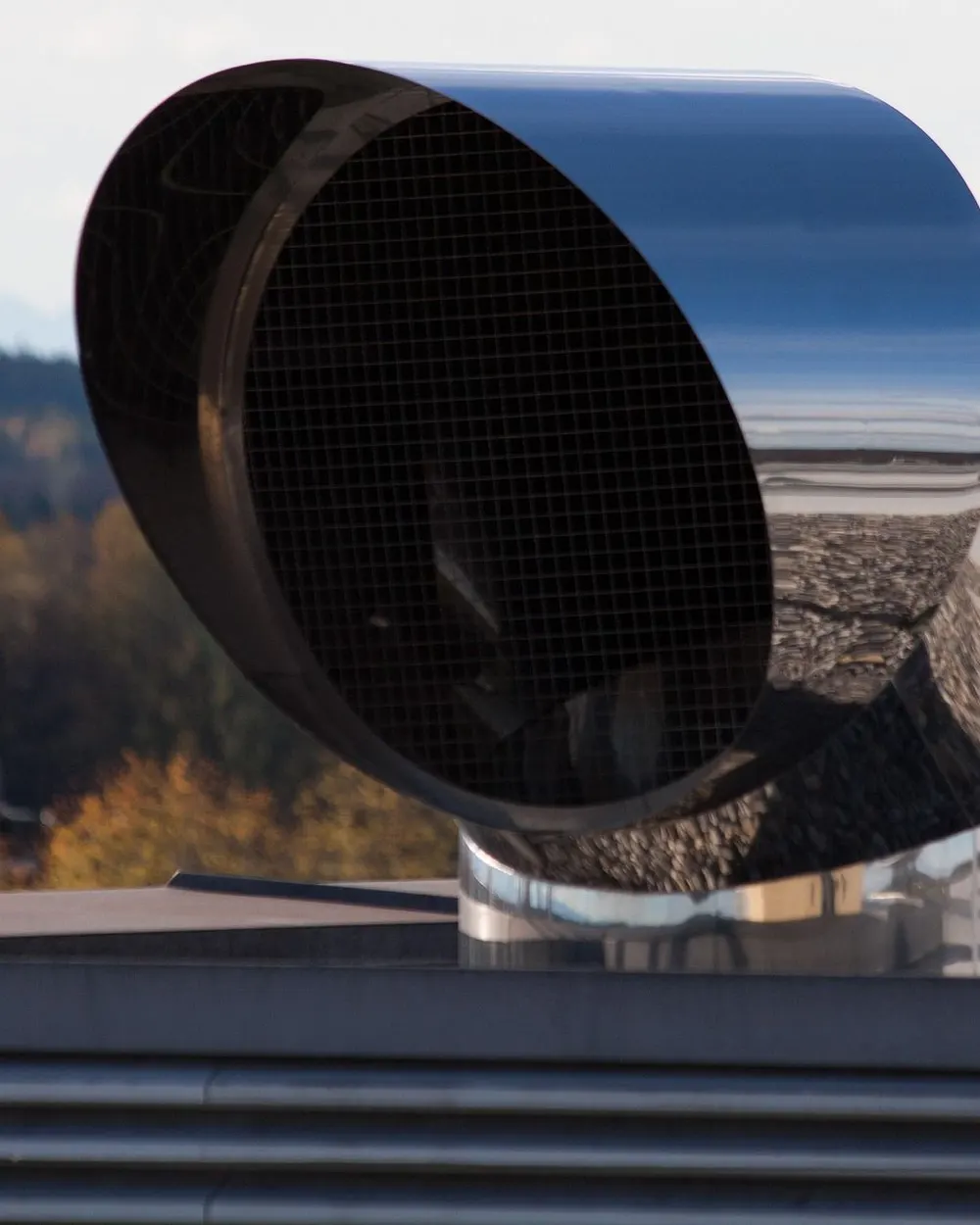 Stainless steel ventilation cap with mesh on a flat roof
