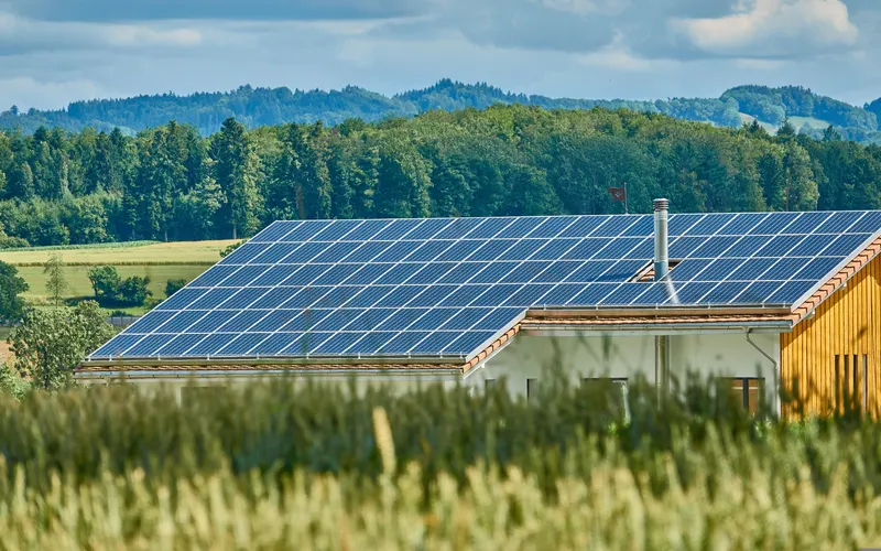 Solar panels covering the roof of a rural building