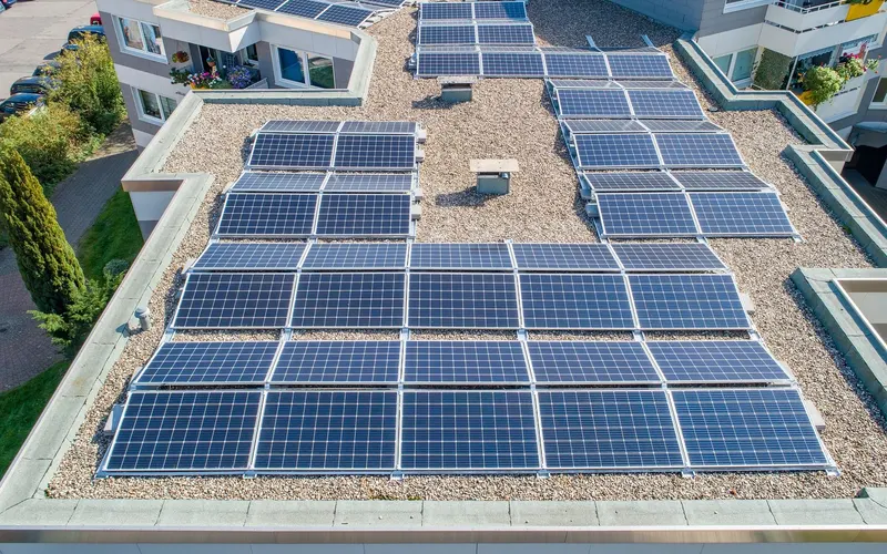 Solar panels on the flat roofs of low-rise buildings, seen from above