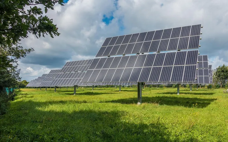 Ground-mounted solar arrays in a grass field