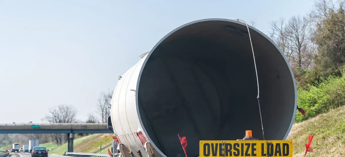 Oversized load on a low-loader trailer travelling along a highway
